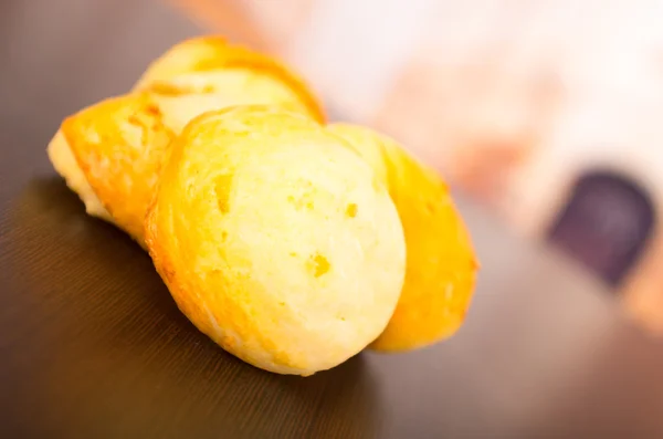 Delicious golden bread on a wooden table — Stock Photo, Image