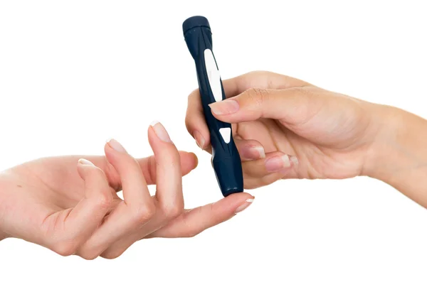 Doctors hand holding glucose measure scanning pen on patients finger with white background — Stock Photo, Image