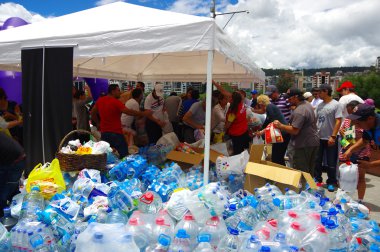 Quito, Ekvator - Nisan, 17, 2016: Afet Yardım gıda, giyim, ilaç ve su kıyılarında deprem kurtulanlar için sağlayan tanımlanamayan vatandaşlar Quito