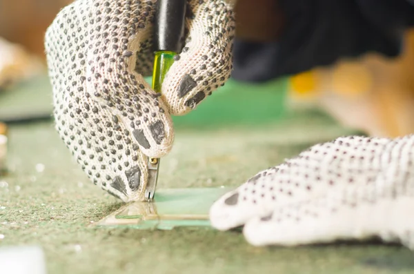 Closeup hand wearing white working glove using handheld cutting engravement tool for glass — Stock Photo, Image