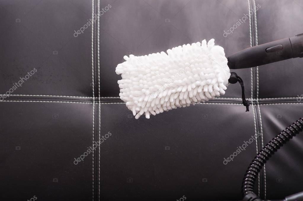 White Fabric Brush From Steam Cleaning Machine Being Used On