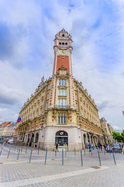Lille, France - June 3, 2015: Famous town hall clock tower as seen from street underneath, beautiful architecture and nice blue sky background — Stock Photo, Image