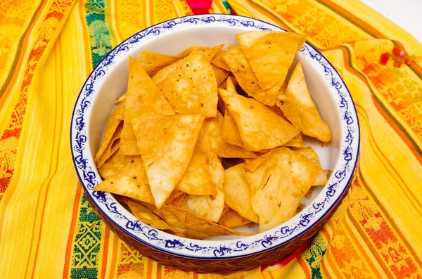 Cuenco de crocantes delicadas tortillas fritas sentadas sobre manteles nativos americanos —  Fotos de Stock