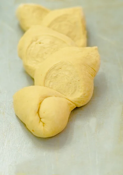 Delicious kringle dough ready for oven lying on metal surface pre cooking — Stock Photo, Image