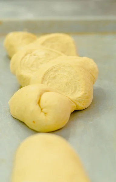 Delicious kringle dough ready for oven lying on metal surface pre cooking — Stock Photo, Image