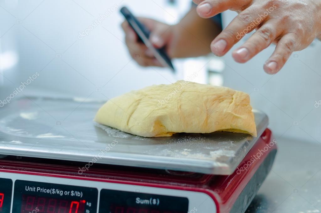 Bakers hands working and weighing bread dough on digital scale Stock Photo  by ©pxhidalgo 114398984