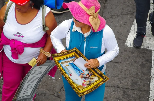 Quito, Ecuador-7 juli 2015: onbekende sportvrouw die een kleine poster van paus Francisco op haar handen houdt — Stockfoto