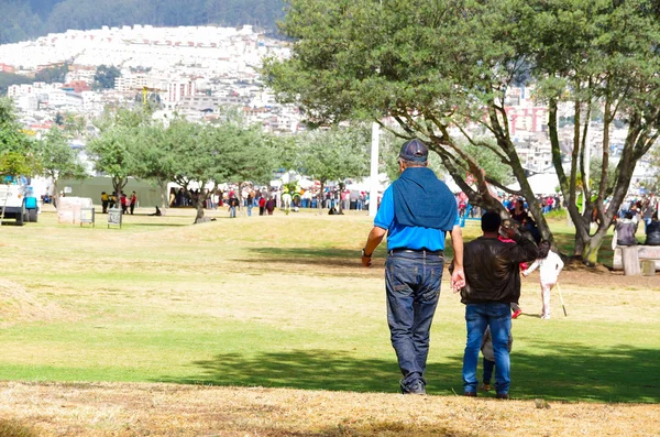 QUITO, ECUADOR - 7 DE JULIO DE 2015: Hombres vistiéndose de color azul caminando para llegar a la misa del Papa Francisco, al final mucha gente — Foto de Stock