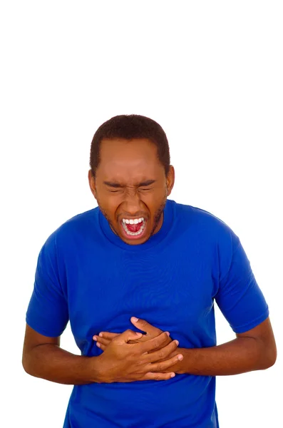 Man wearing strong blue t-shirt standing and laughing hard holding his stomach, white studio background — Stock Photo, Image