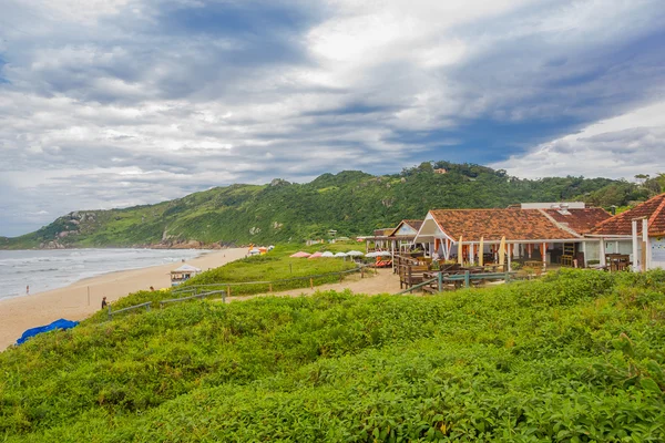 FLORIANOPOLIS, BRASIL - MAIO 08, 2016: bela vista da toupeira da praia com alguns restaurantes em frente à praia e alguns quantidade como fundo — Fotografia de Stock