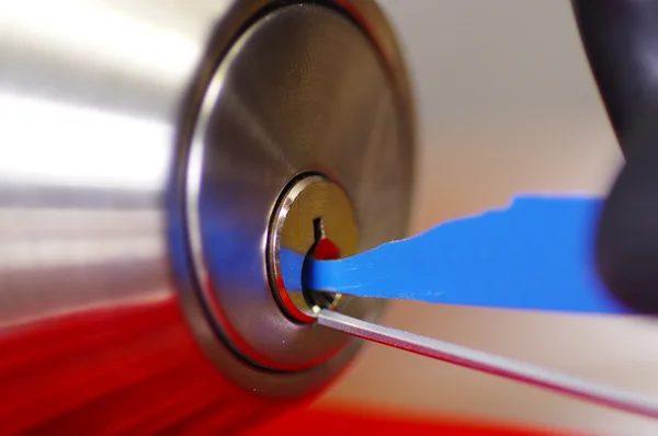 Closeup hands of locksmith using pick tools to open locked door — Stock Photo, Image