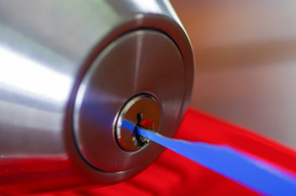 Closeup hands of locksmith using metal pick tools to open locked door — Stock Photo, Image