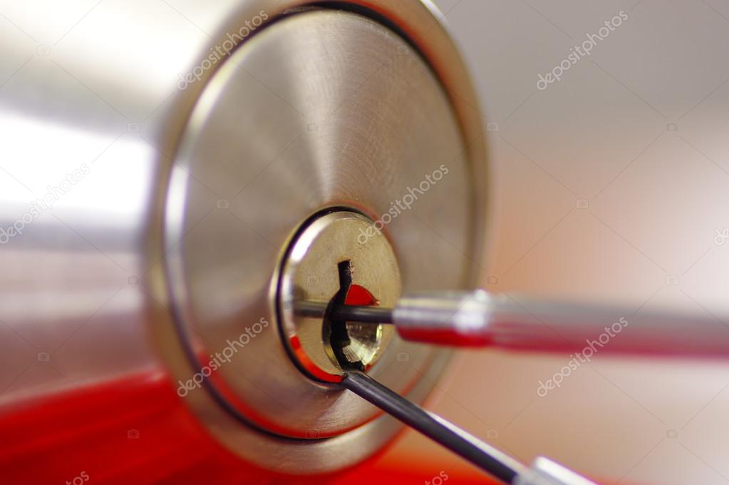 Closeup Hands Of Locksmith Using Metal Pick Tools To Open