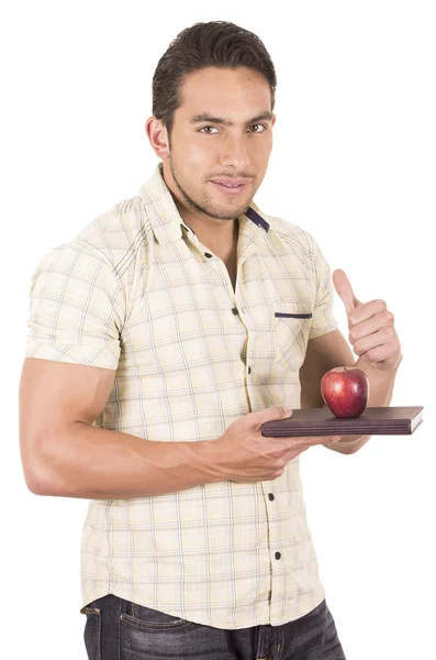 Joven feliz maestro masculino sosteniendo cuaderno y manzana roja — Foto de Stock