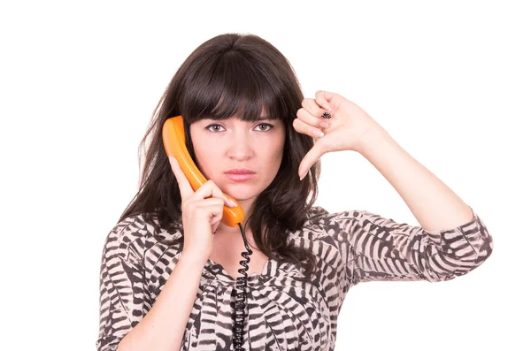 Mooie jonge vrouw via retro oranje telefoon — Stockfoto