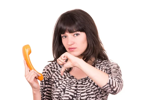 Mooie jonge vrouw via retro oranje telefoon — Stockfoto