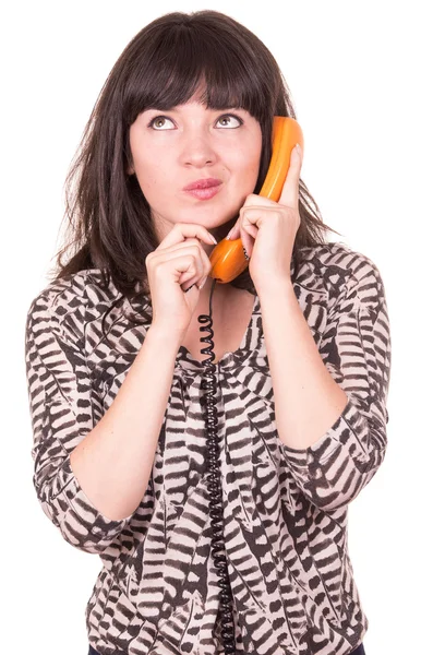 Mooie jonge vrouw via retro oranje telefoon — Stockfoto