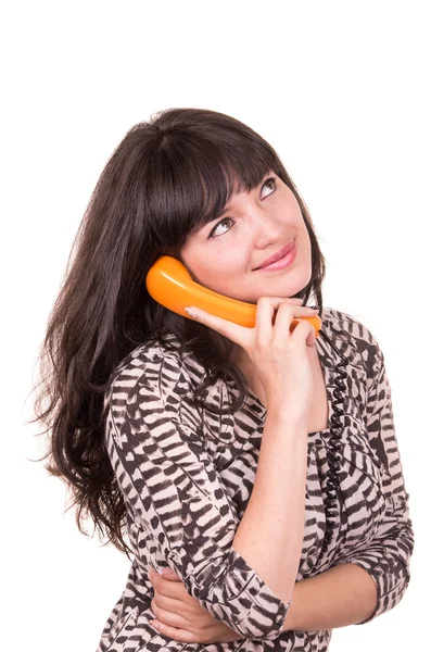 Mooie jonge vrouw via retro oranje telefoon — Stockfoto