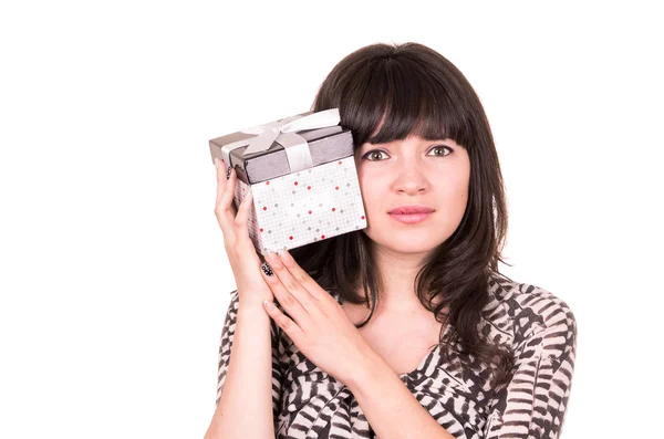 Beautiful young girl holding present wrapped in a box — Stock Photo, Image