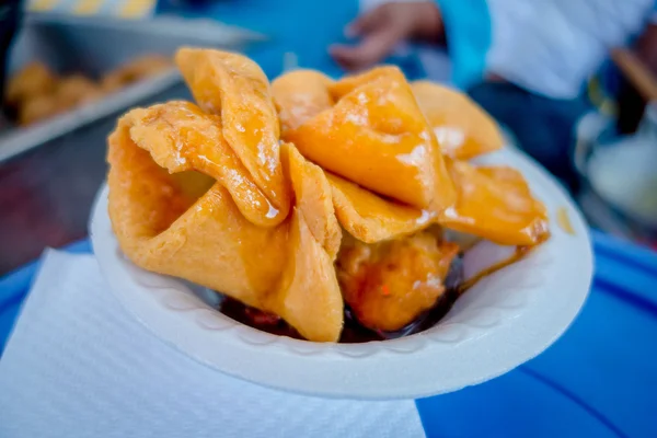 Bunuelos close up, traditional ecuadorian dessert served with honey and brown sugar — Stock Photo, Image