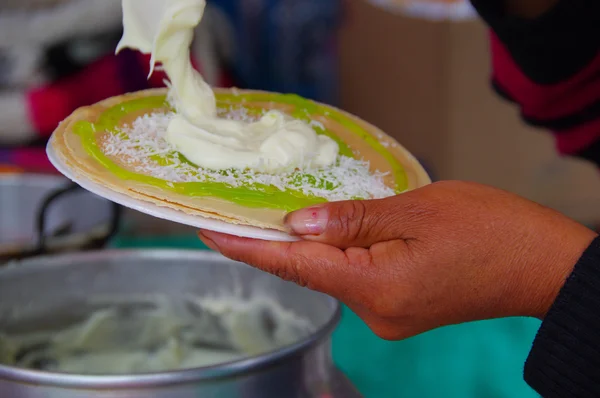 PASTO, COLOMBIE - 3 JUILLET 2016 : femme préparant un dessert aux gaufrettes, sirop de kiwi, noix de coco et crème — Photo