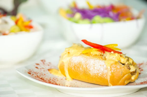 Philly cheese steak delicate serving on white plate, melted cheddar and grease pouring out of bread — Stock Photo, Image