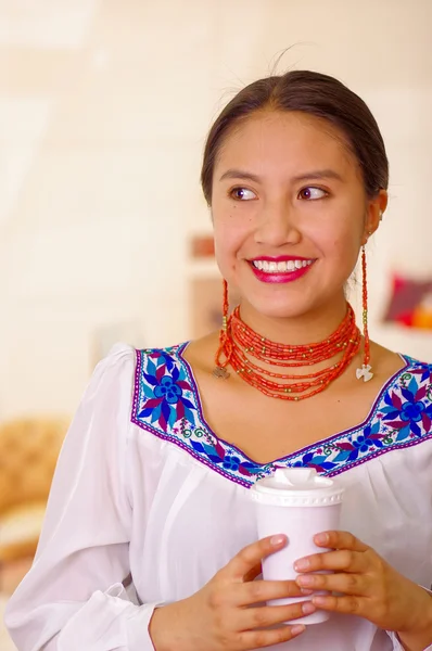 Foto de la cabeza bonita mujer joven con blusa andina tradicional, sosteniendo taza de café blanco, frente a la cámara, sonrisa hermosa — Foto de Stock