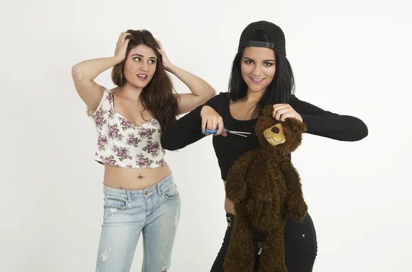 Two playful young girls with a teddy bear — Stock fotografie