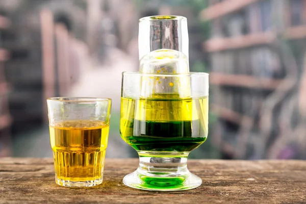 Yellow green cocktail inside a glass and shot — Stock Photo, Image