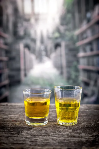 Glass shots with yellow liqour resembling whiskey, rum, tequila, spirit — Stock Photo, Image