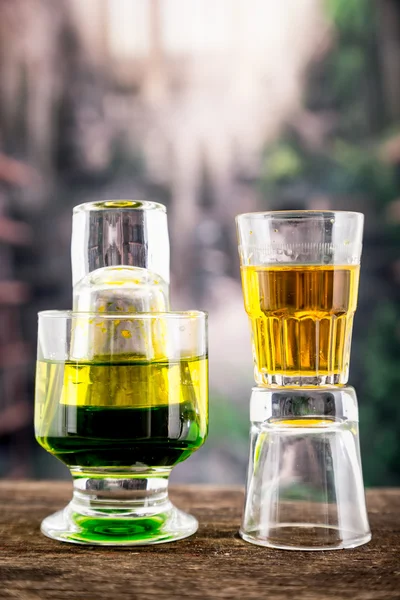 Yellow green cocktail inside a glass and shot — Stock Photo, Image