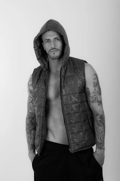 Young brunette shirtless male model wearing a vest — Stock Photo, Image