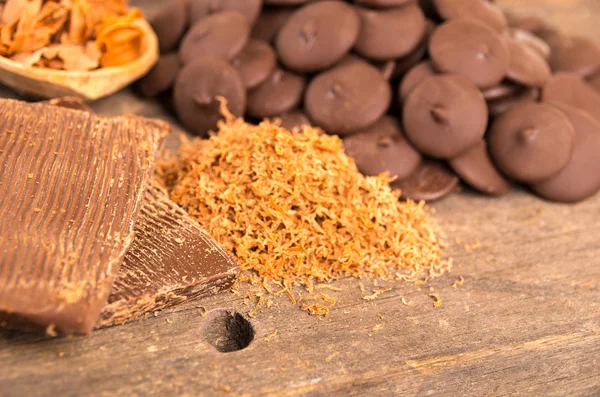 Shredded chocolate on a wooden table — Stock Photo, Image