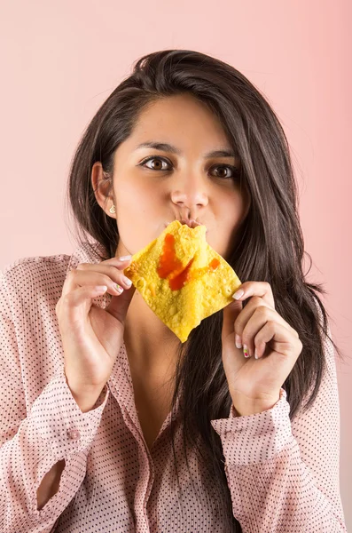 Young brunette girl eating chinese wonton cracker snack — Stock Photo, Image