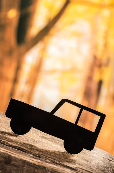 Cut out car silhouette over forest background — Stock Photo, Image