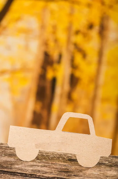 Cut out paper car silhouette over forest background — Stock Photo, Image