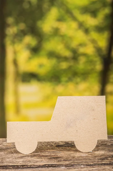 Cut out paper car silhouette over forest background — Stock Photo, Image