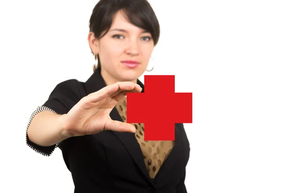 Young beautiful girl holding drawn red cross in her hand — Stock Photo, Image