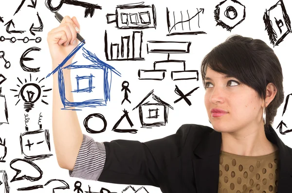Young beautiful woman drawing a house with marker — Stock Photo, Image