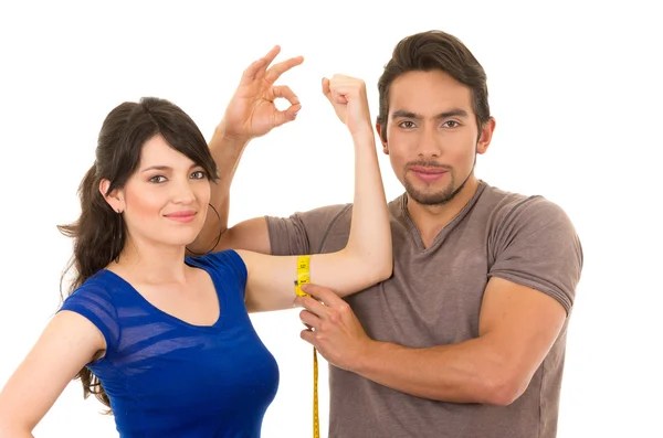 Handsome man holding measuring tape around thin young girl — Stock Photo, Image