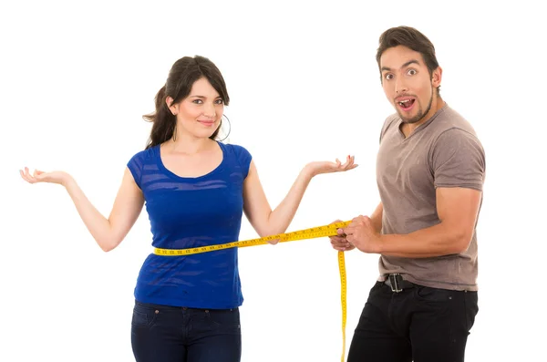 Handsome man holding measuring tape around thin young girl — Stock Photo, Image