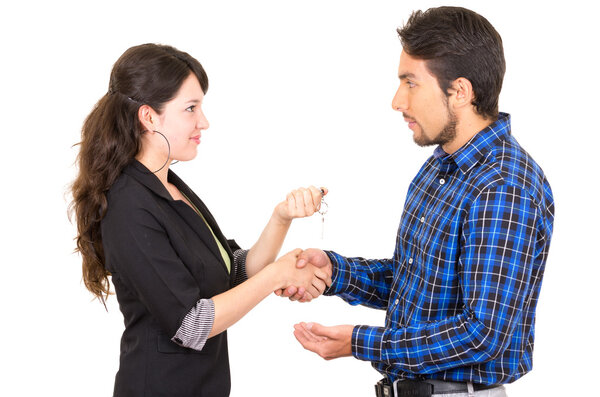young beautiful woman handing over key to man