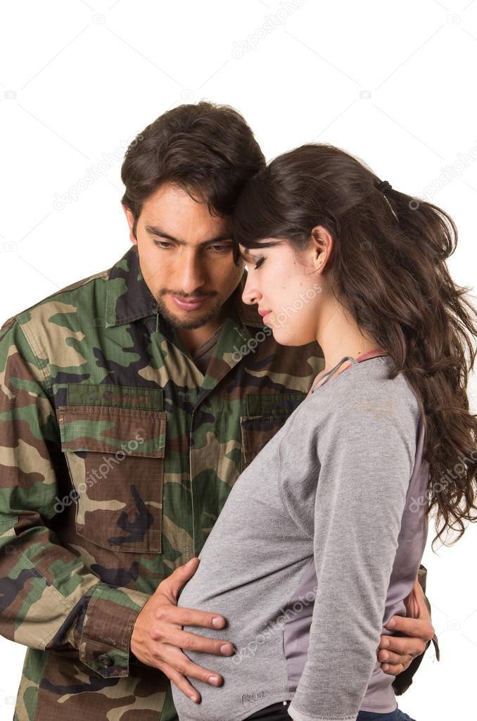 proud military soldier hugging pregnant wife