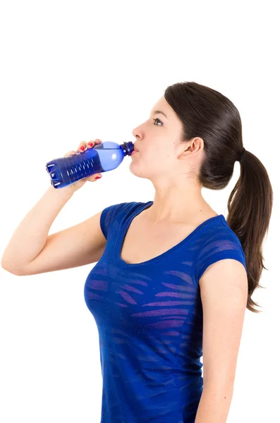 Beautiful young girl drinking water from blue bottle — Stock Photo, Image