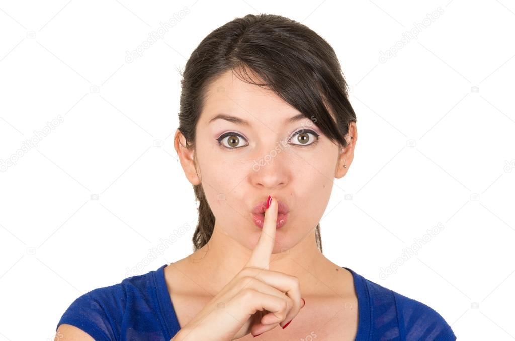 beautiful young woman gesturing silence shhh with finger on mouth
