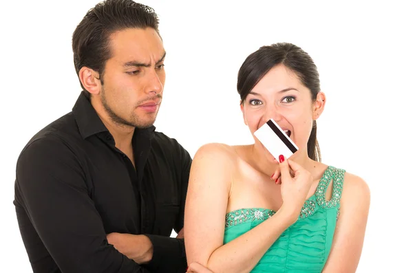 Worried man looking at shopaholic wife holding credit card — Stock Photo, Image