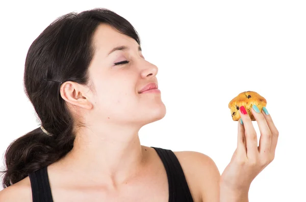 Beautiful young happy woman holding a muffin — Stock Photo, Image