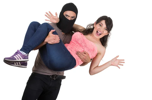 Male thief kidnapping carrying young girl — Stock Photo, Image