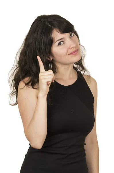 Beautiful young brunette woman wearing black top posing with one finger up Royalty Free Stock Photos