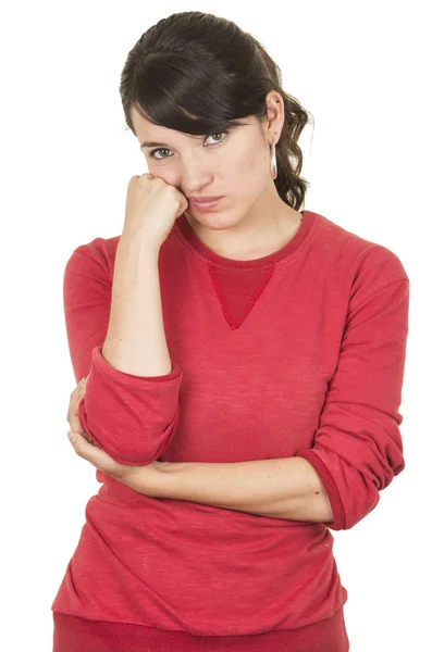 Menina bonita vestindo top vermelho posando com a mão na bochecha olhando entediado — Fotografia de Stock